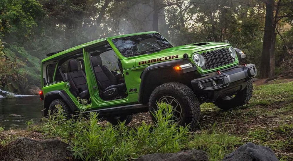 A green 2026 Jeep Wrangler Rubicon parked off-road.