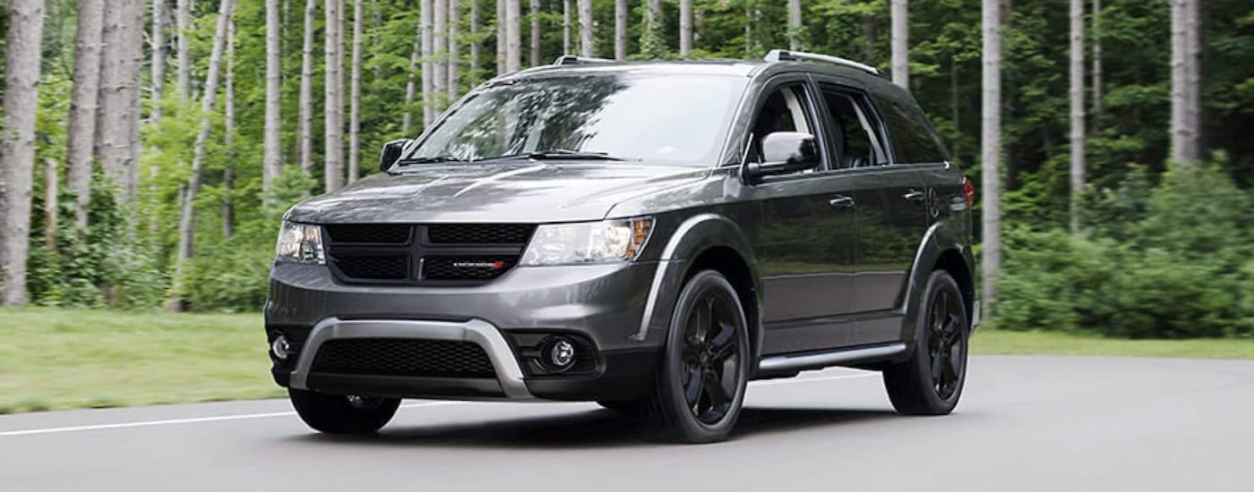 Silver 2020 Dodge Journey driving down a road.