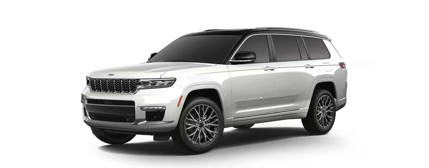 A white 2025 Jeep Grand Cherokee angled left.