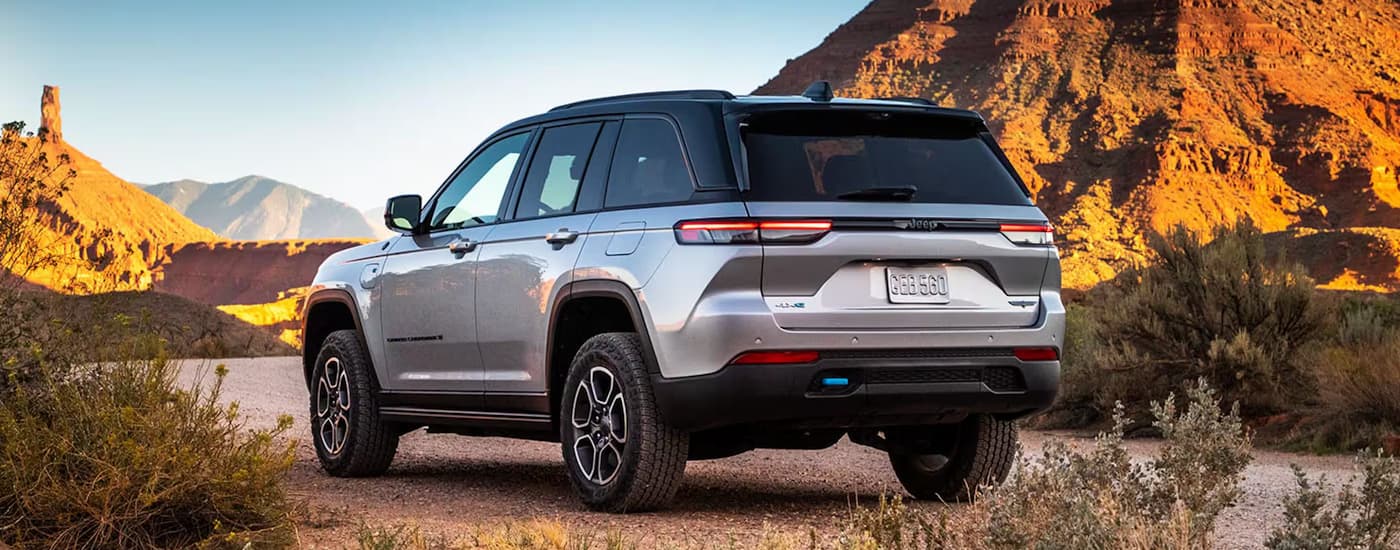 Rear of a white 2026 Jeep Grand Cherokee parked off-road.