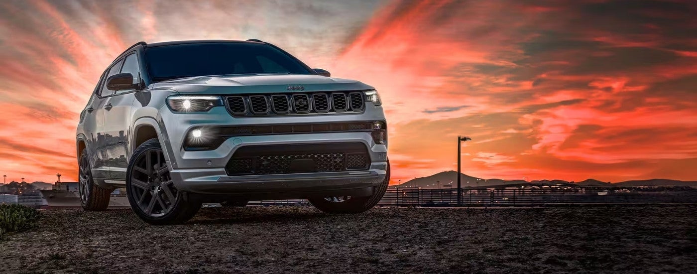 Silver 2025 Jeep Compass parked off-road.
