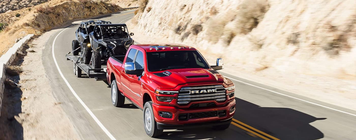High view of a red 2026 Ram 2500 driving down a road.
