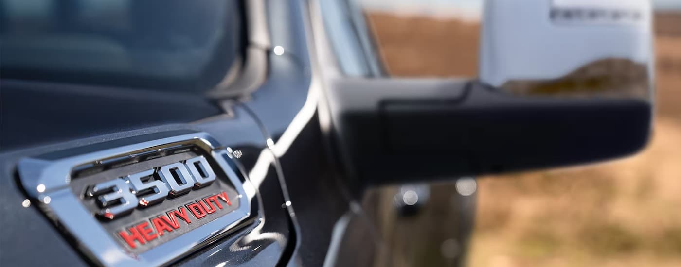 Close up of the side mirror on a black 2025 Ram 3500 at a Ram dealer